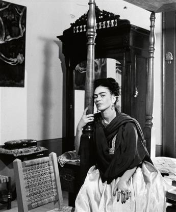 BRAVO, LOLA ALVAREZ (1907-1993) Frida with arm around bedpost, Casa Azul, Mexico.